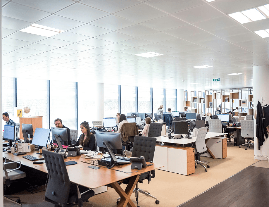 Open plan office workspace with teams collaborating